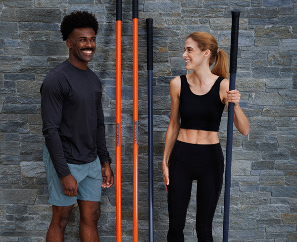 Man and woman with their Stick Mobility Training Sticks