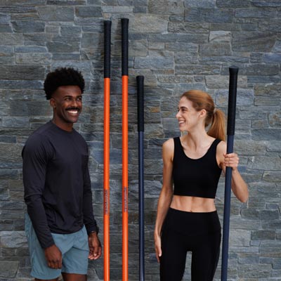 Man and woman with their Stick Mobility Training Sticks