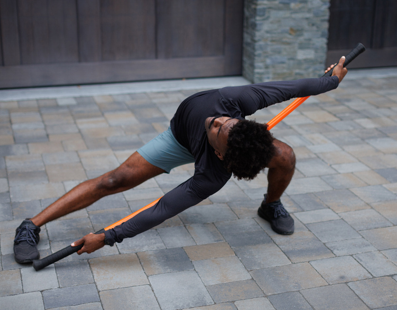 Man displaying flexibility with Stick Mobility training stick