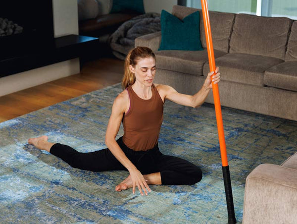 Woman stretching with Stick Mobility Training Stick