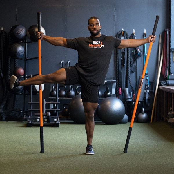 Man exercising with two Stick Mobility training sticks